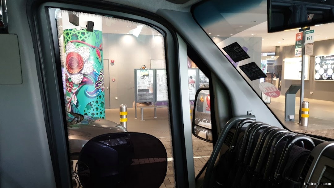 View from inside a vehicle, looking out at a building exterior.