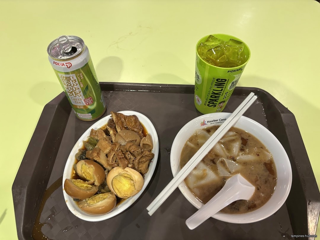 A tray with Kway Chap, drinks, and soup is shown.