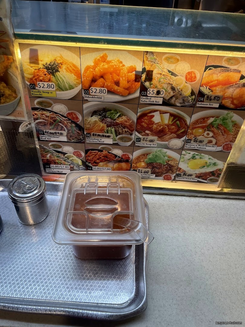 The image shows a menu board with pictures and prices of Korean dishes.