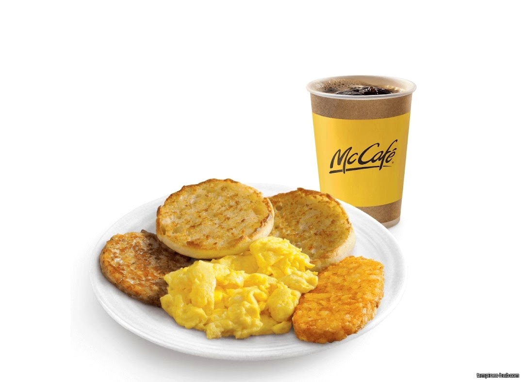 McDonald's breakfast plate with eggs, muffin, sausage, hash brown, and McCafe coffee.