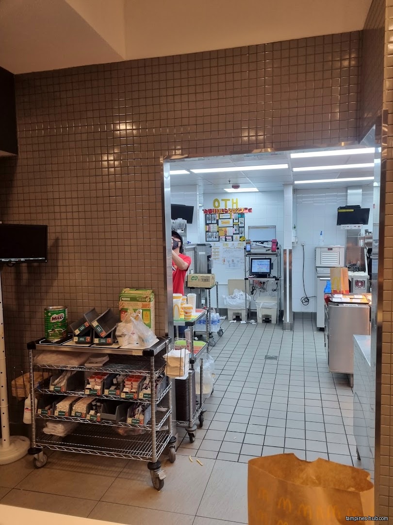 A view into the McDonald's kitchen area with carts and equipment.