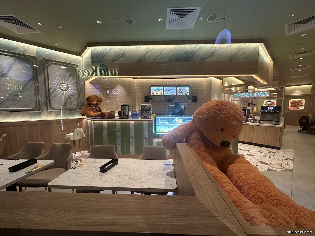 Interior view of Milan Cafeteria with tables, chairs, and large teddy bears.