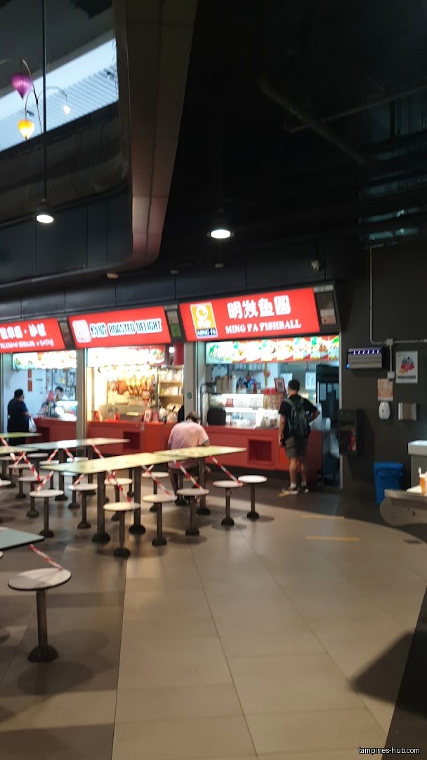 Ming Fa Fishball shop front with tables and customers.