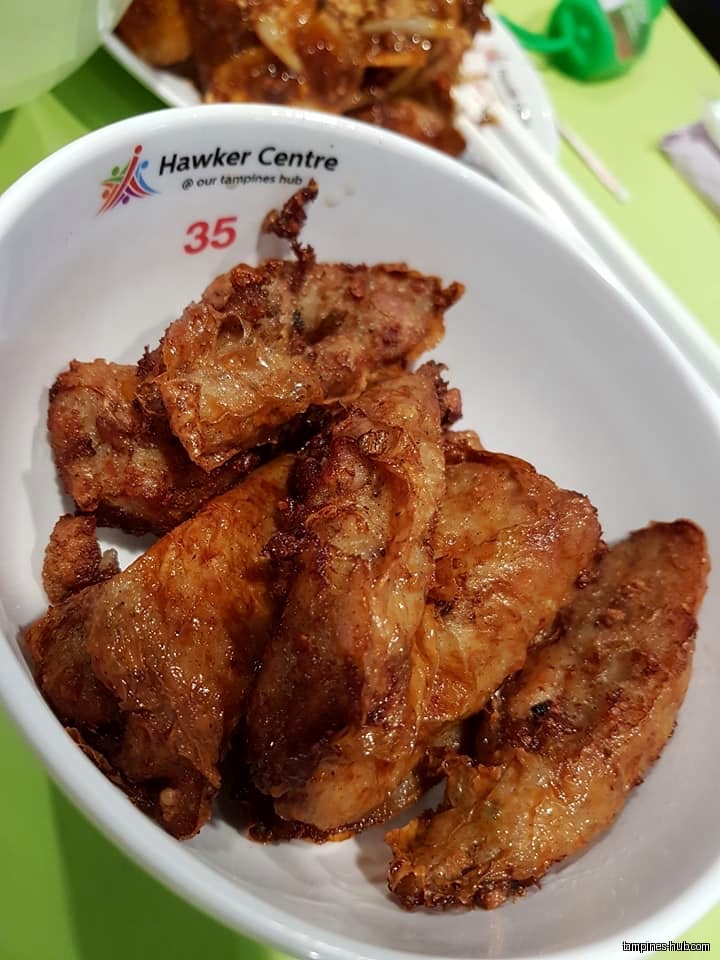 A bowl of fried food from a hawker centre stall.