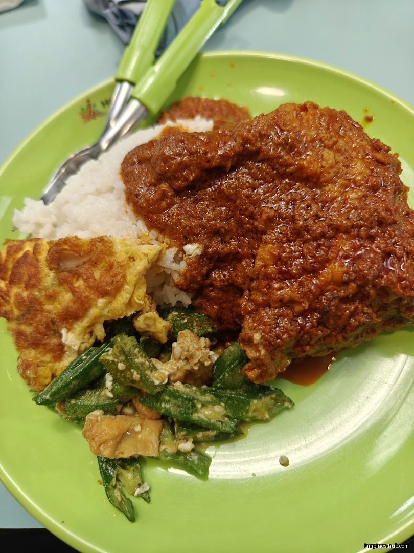 A plate of rice with rendang, omelet, and okra is shown.