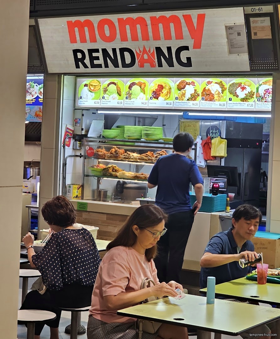 Mommy Rendang shop front with menu board and customers eating.