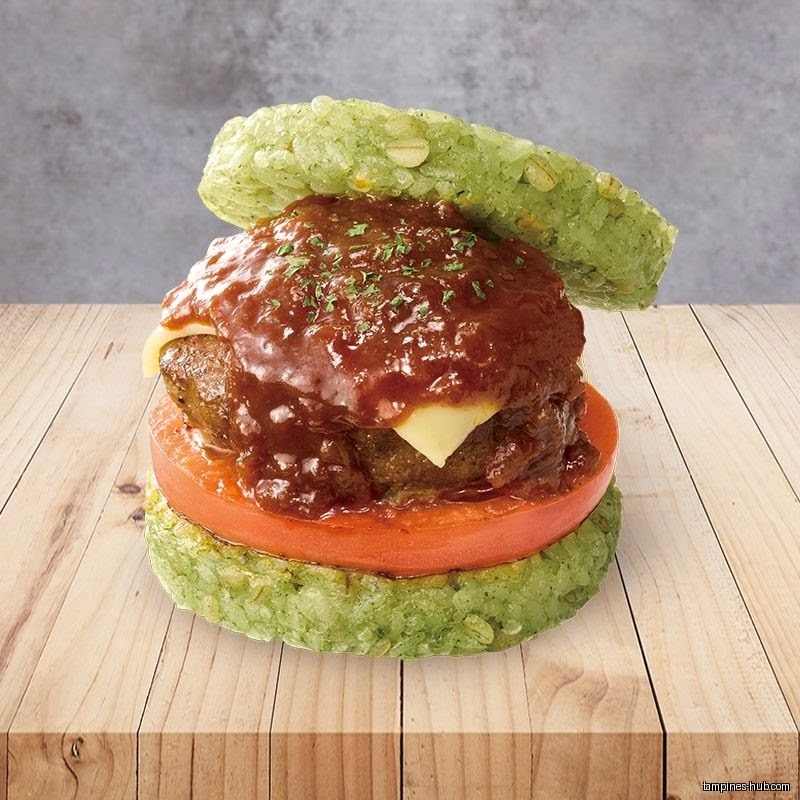 A rice burger with a beef patty, cheese, tomato, and sauce is displayed.
