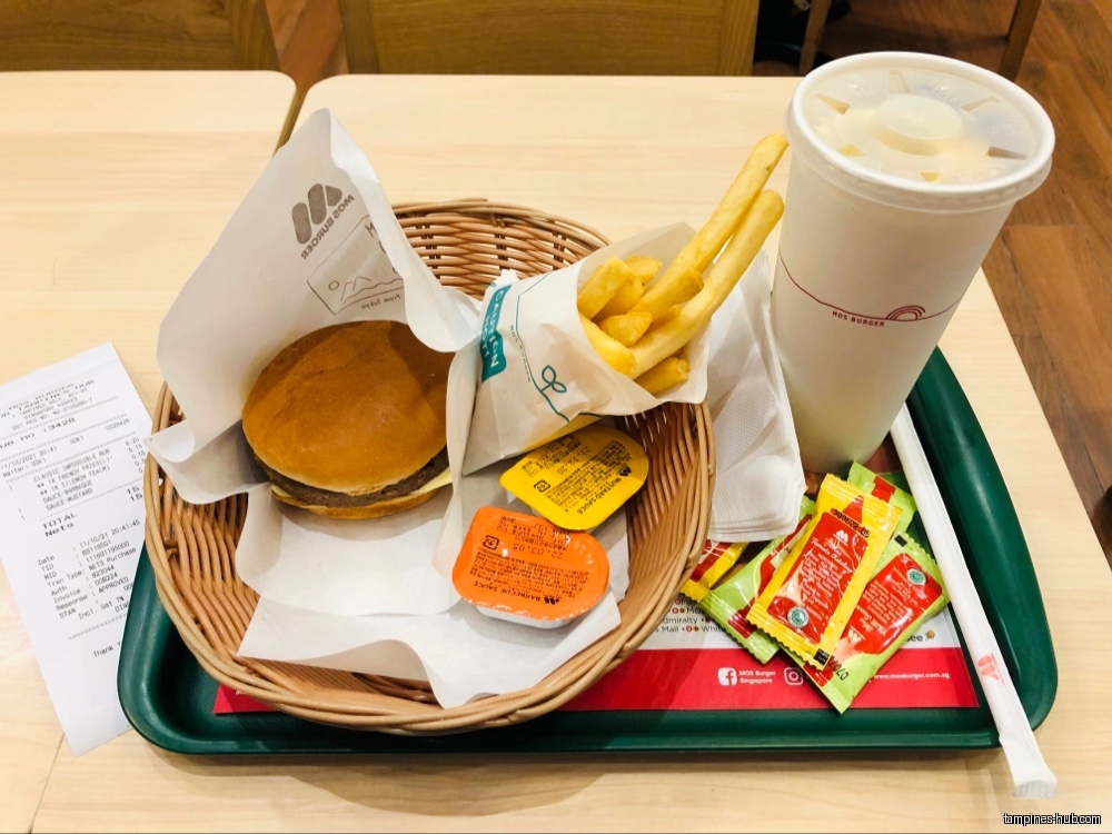 A Mos Burger meal with burger, fries, drink, sauces, and receipt.