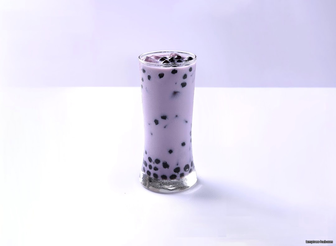 A glass of purple bubble tea with black tapioca pearls.