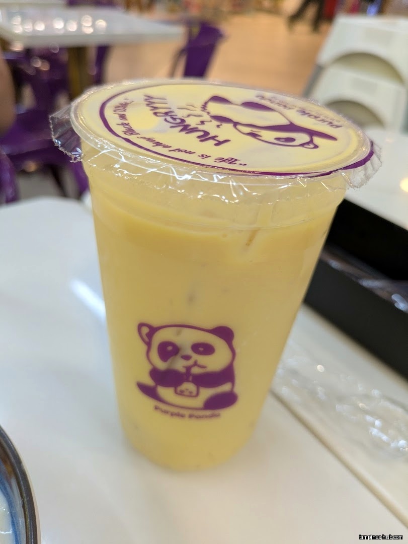 A yellow drink in a plastic cup with a Purple Panda logo.