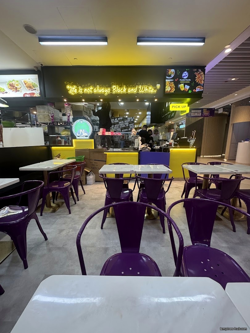 Interior view of Munch Mania by Purple Panda with tables and chairs.