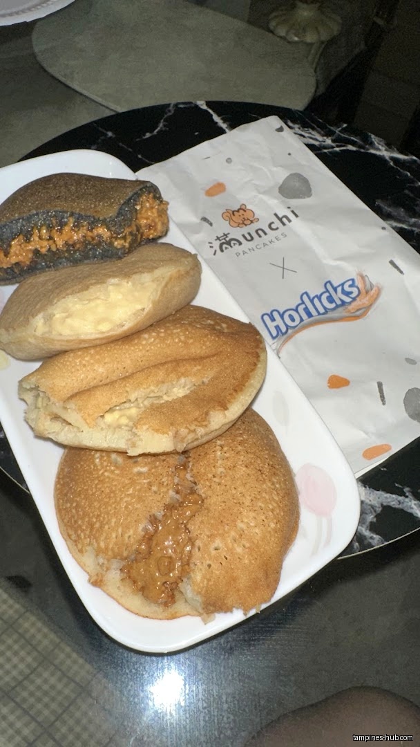 A plate of Munchi Pancakes with various fillings and a branded paper bag.