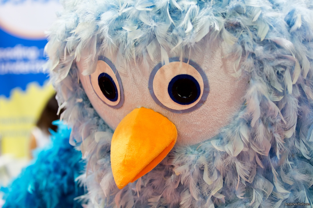 Close-up of a blue bird mascot with an orange beak.