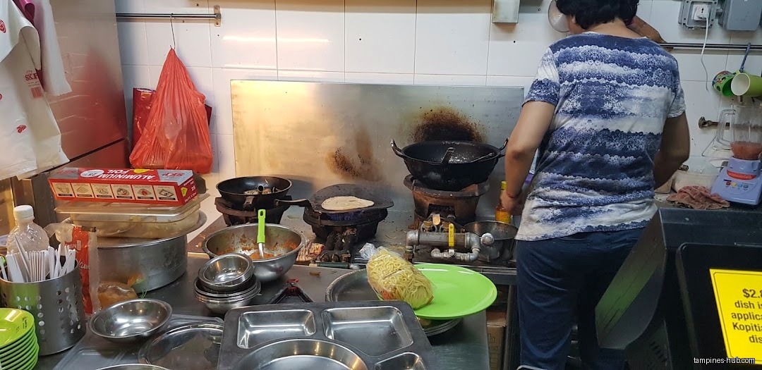 Inside My Happy Belly, a person cooks food on a stove.