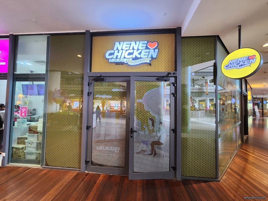NeNe Chicken shop front with glass doors and logo signage.