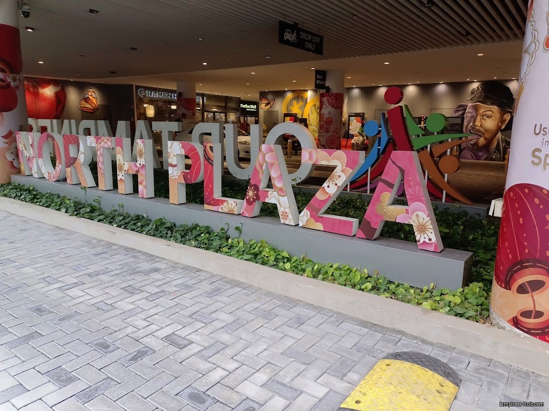 The image shows the entrance of North Plaza with a large sign.