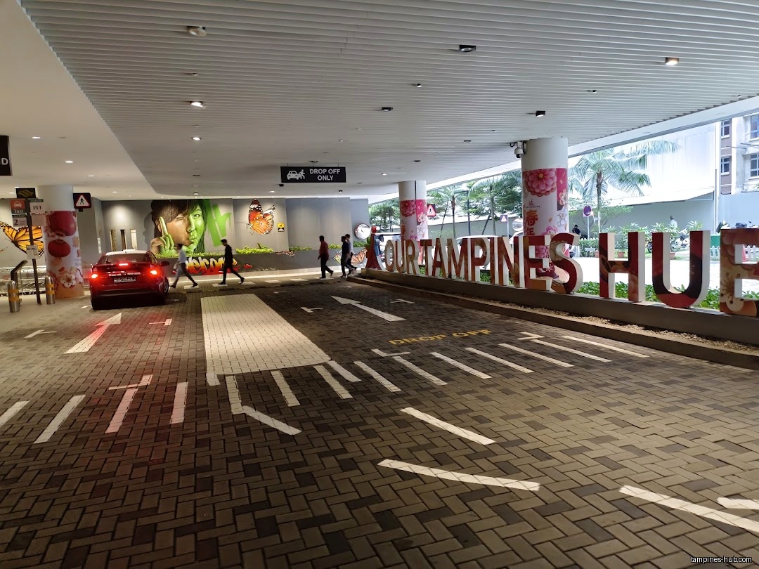 The image shows the entrance to Our Tampines Hub with a drop-off zone.