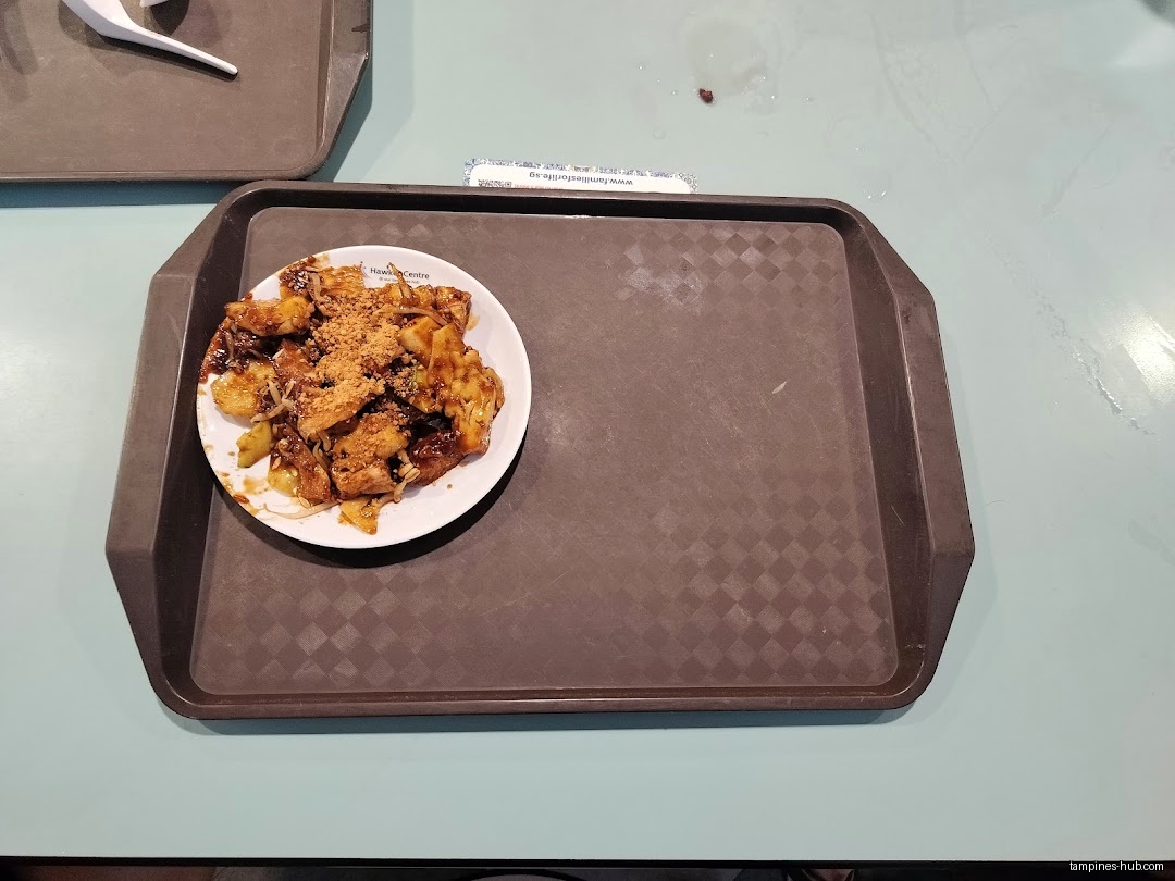 A plate of Rojak on a brown tray, sitting on a table.