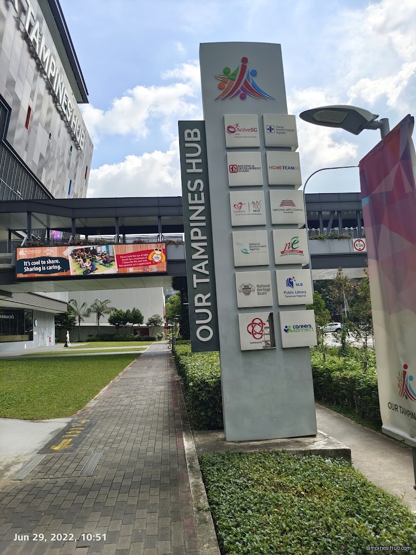 Image shows the exterior signage for Our Tampines Hub with various logos.