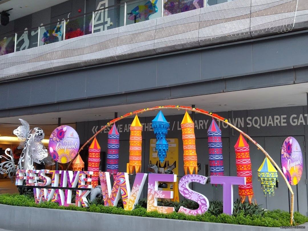 The shop front has a festive Deepavali decoration and signage.