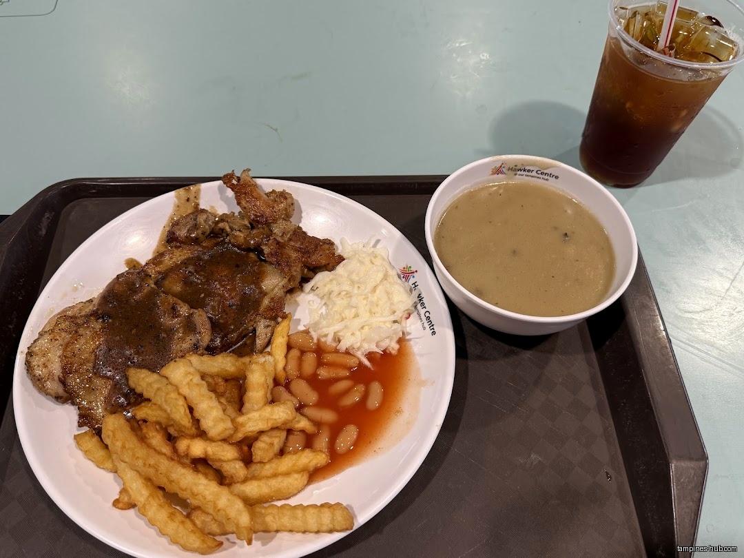 A plate of western food with fries, beans, coleslaw, and soup.