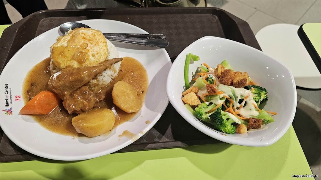 A plate of food with rice, egg, meat, and a side salad.
