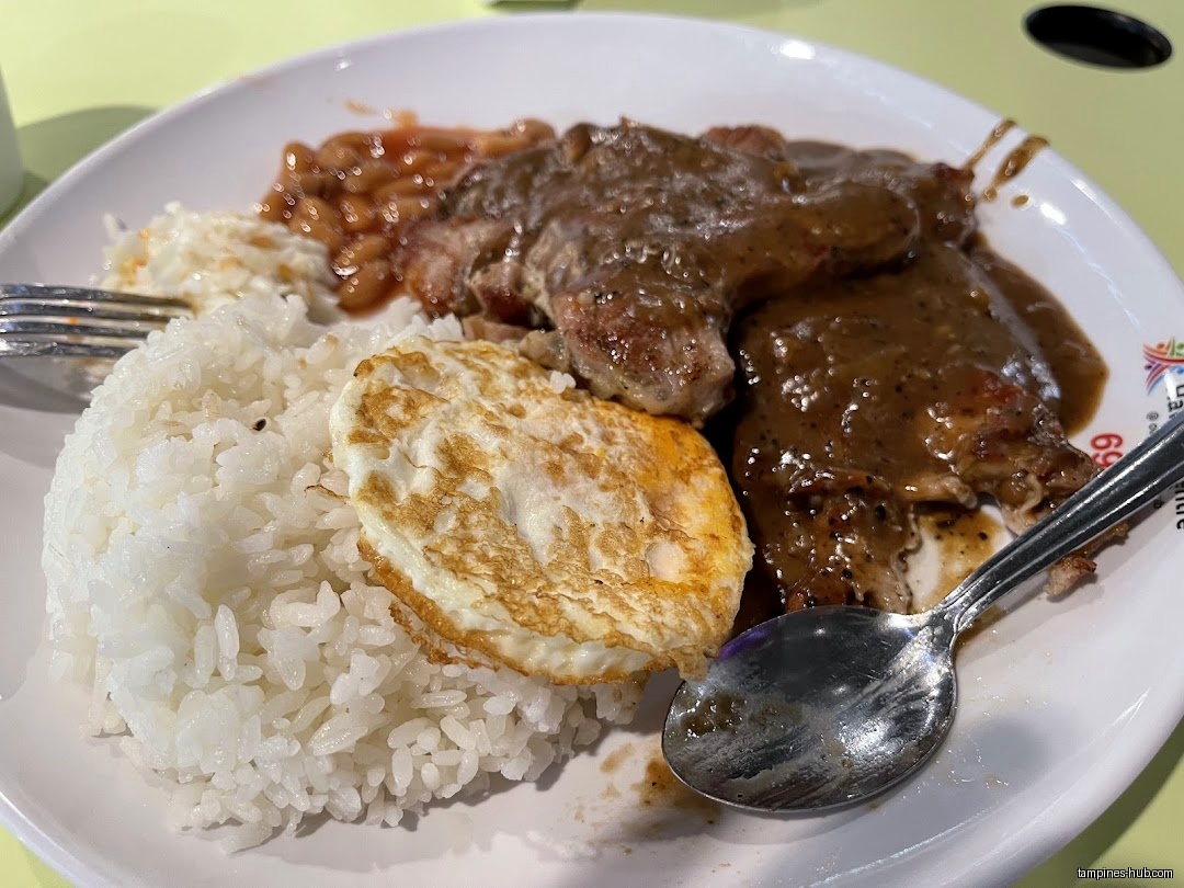 A plate of food with rice, egg, meat, beans, and coleslaw.