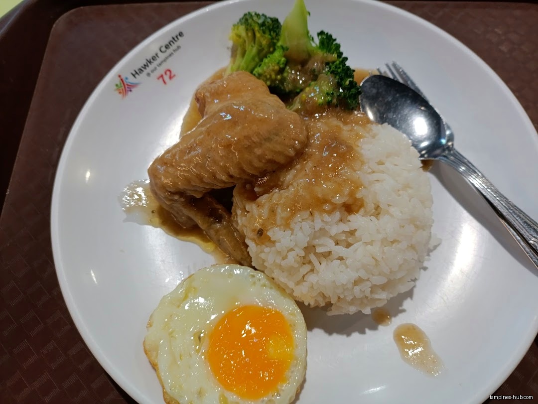 A plate of rice, chicken wings, broccoli, and a fried egg.