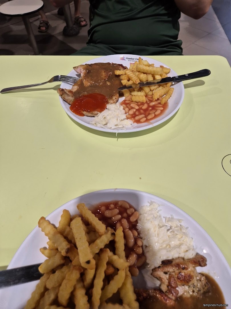 Two plates of Western food with fries, beans, coleslaw, and chicken.