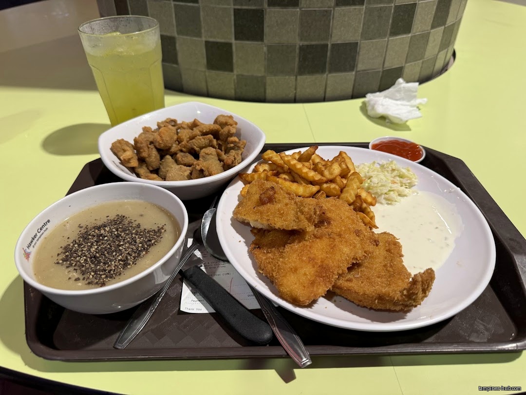 A tray with fried fish, fries, soup, and a drink is shown.