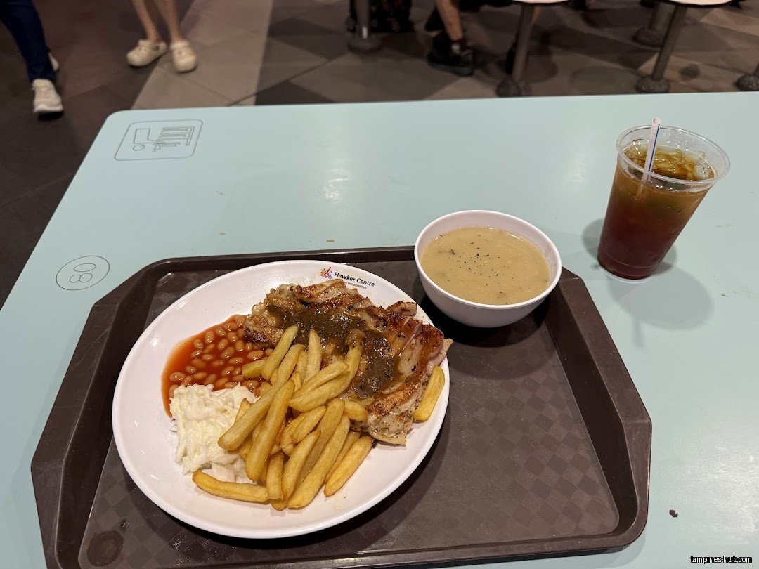 A plate of chicken chop with fries, beans, coleslaw, soup and a drink.