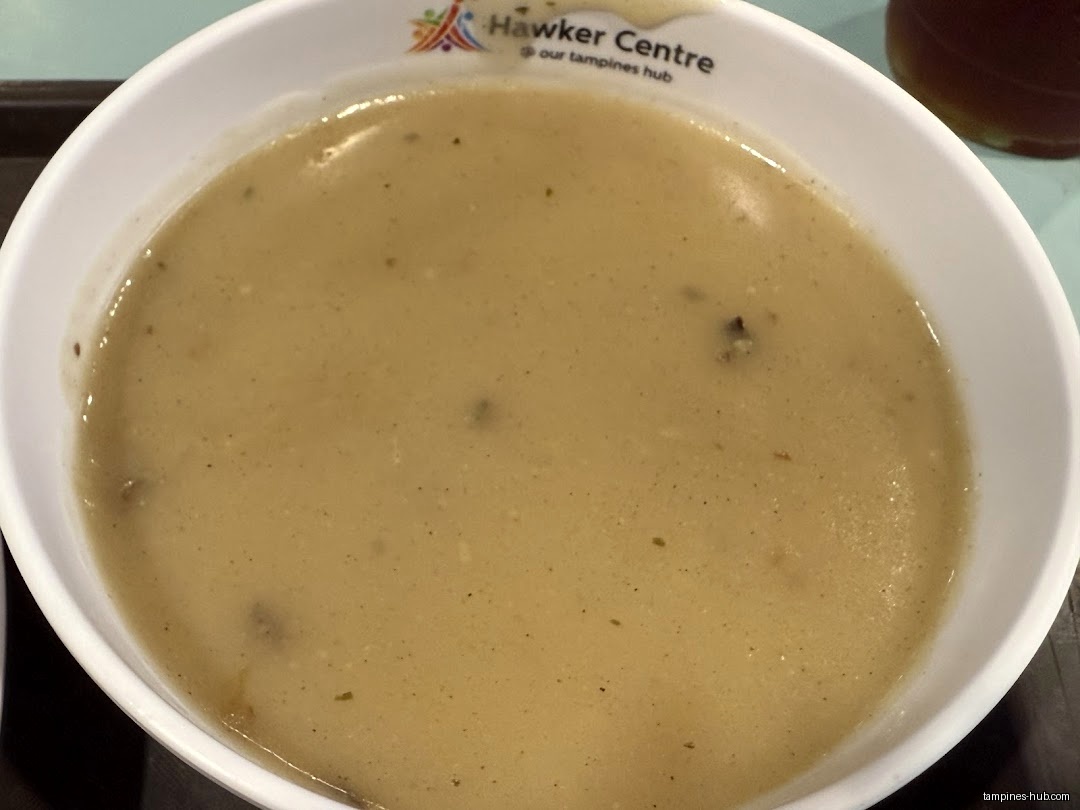 A bowl of mushroom soup from a hawker centre is shown.
