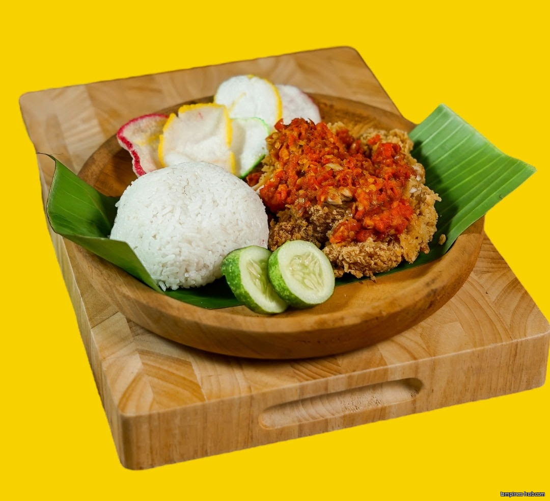 Ayam Geprek (crispy fried chicken with chili) served with rice and crackers.