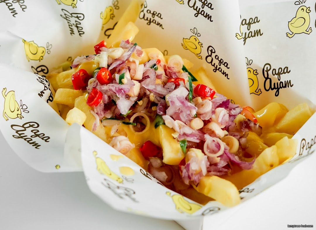 Fries topped with a colorful mix of onions, peppers, and other ingredients.
