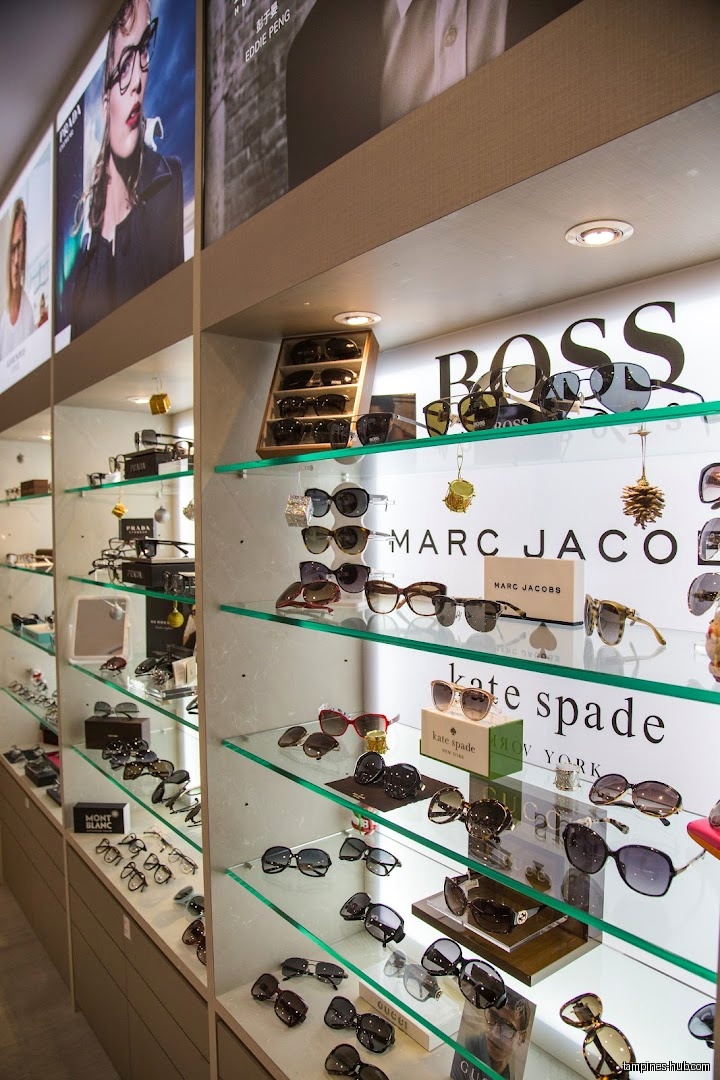 The image shows a display case filled with various brands of sunglasses.
