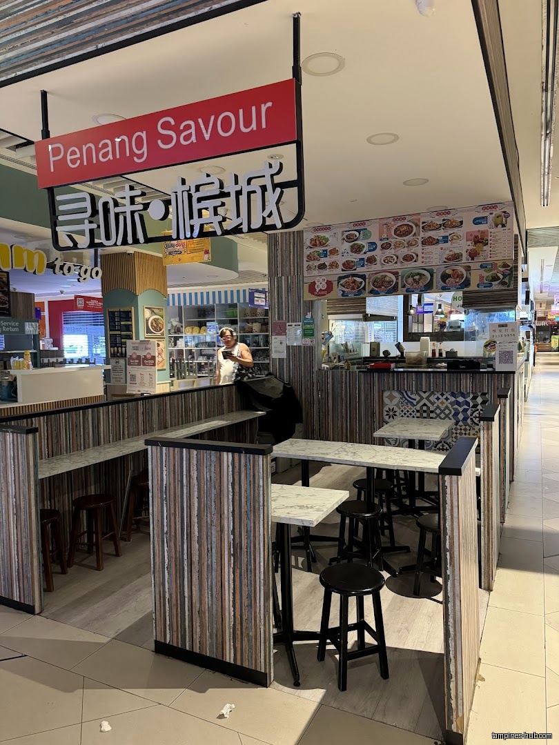 Penang Food Cuisine PTE LTD shop front with tables and menu board.