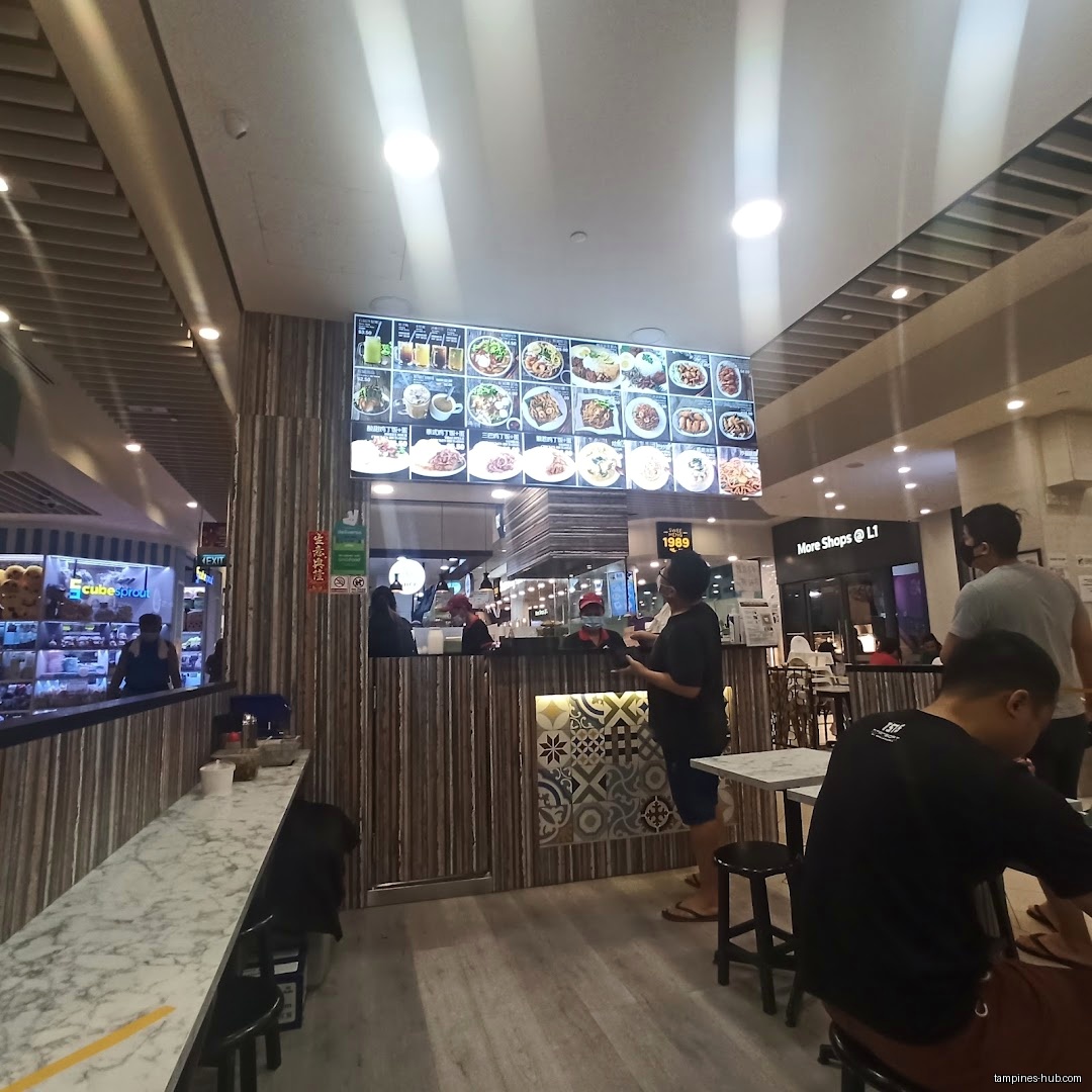 Interior view of Penang Food Cuisine with menu board and customers.