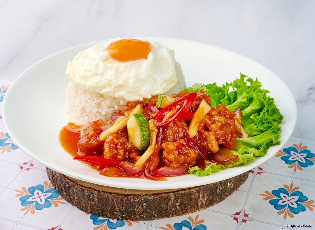 A plate of rice, fried egg, and sweet and sour chicken is shown.
