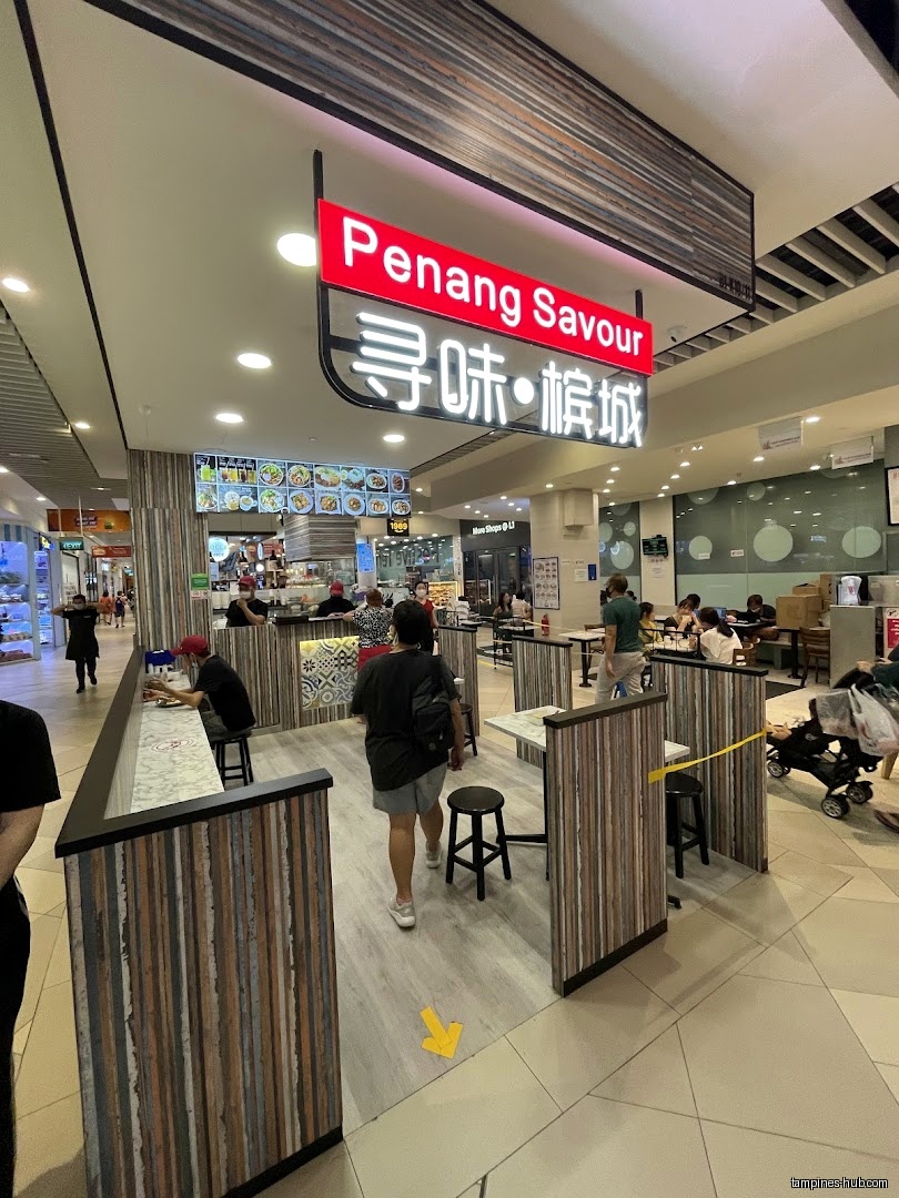 Penang Savour restaurant entrance with menu board and seating area visible.