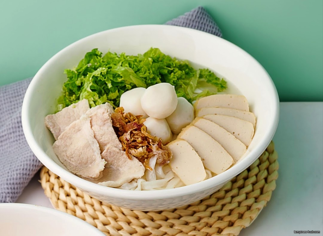 A bowl of Penang Savour noodle soup with various toppings.