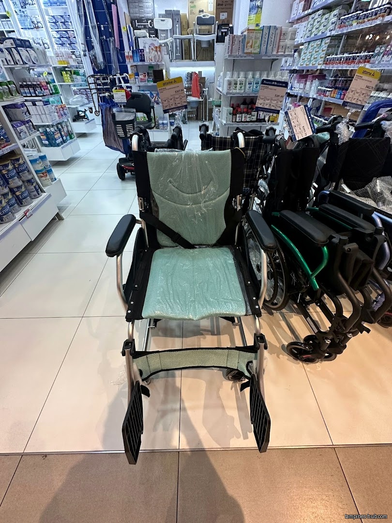 The image shows a wheelchair inside Pharmex Healthcare - Our Tampines Hub.