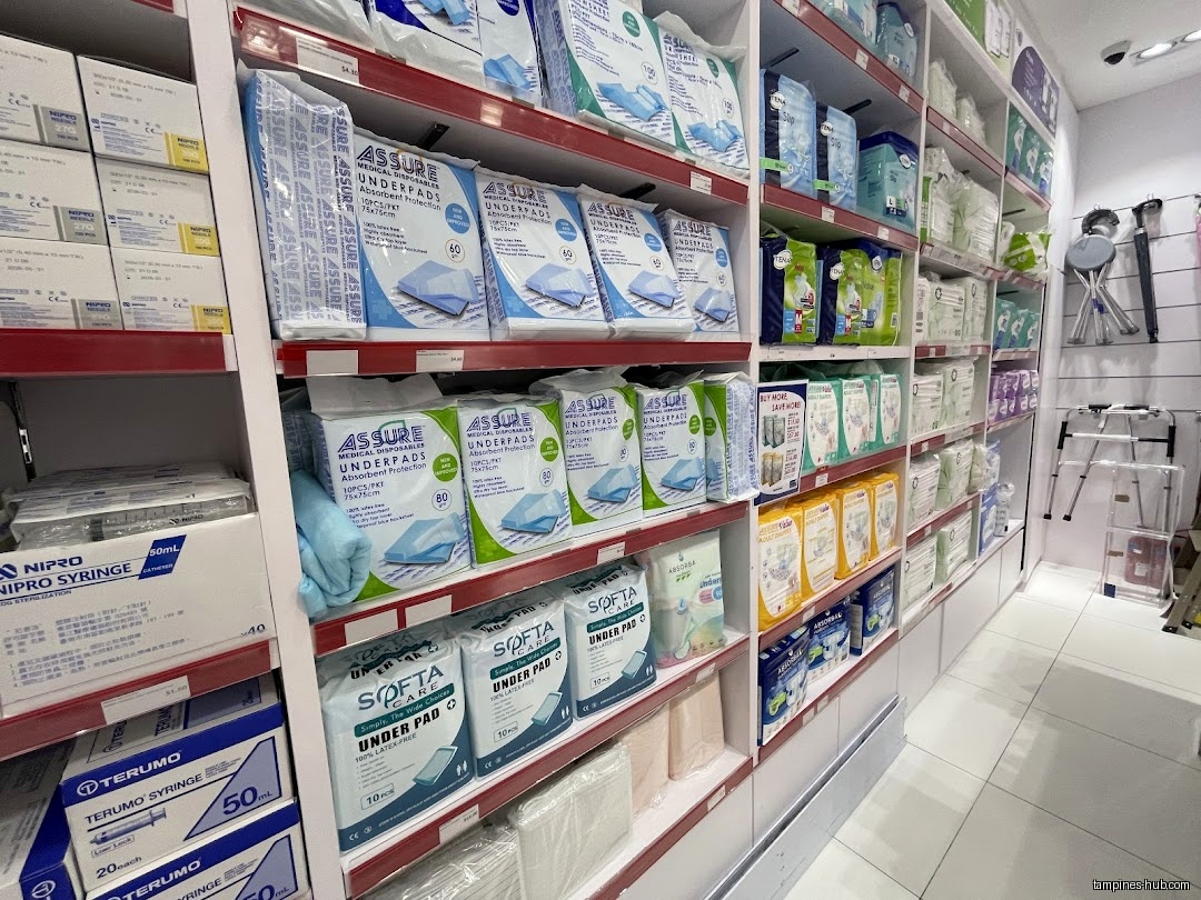 Shelves stocked with medical supplies, including underpads and syringes, in a pharmacy.