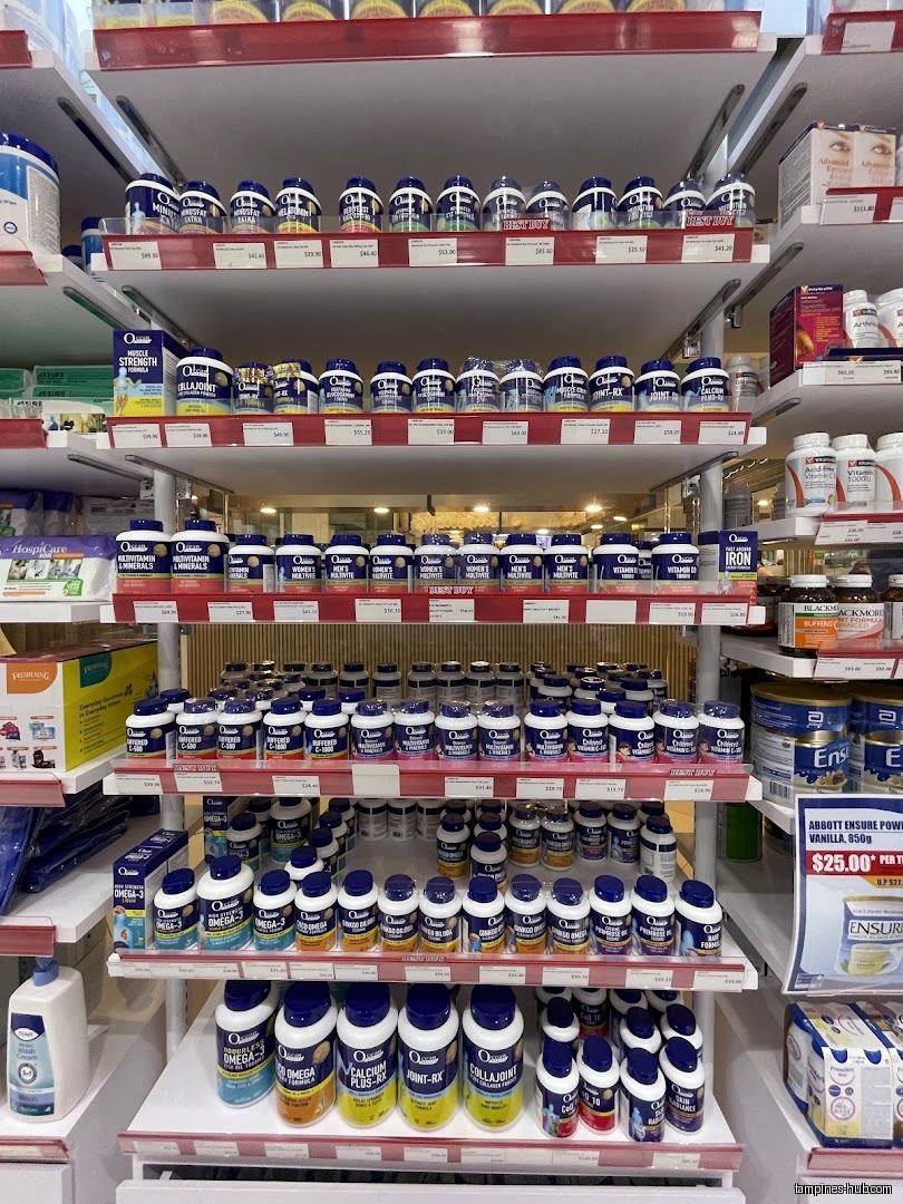 Shelves stocked with various vitamin and supplement products in a pharmacy.