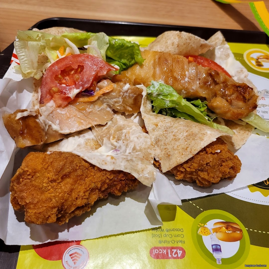 A tray with wraps filled with chicken, fish, and vegetables.