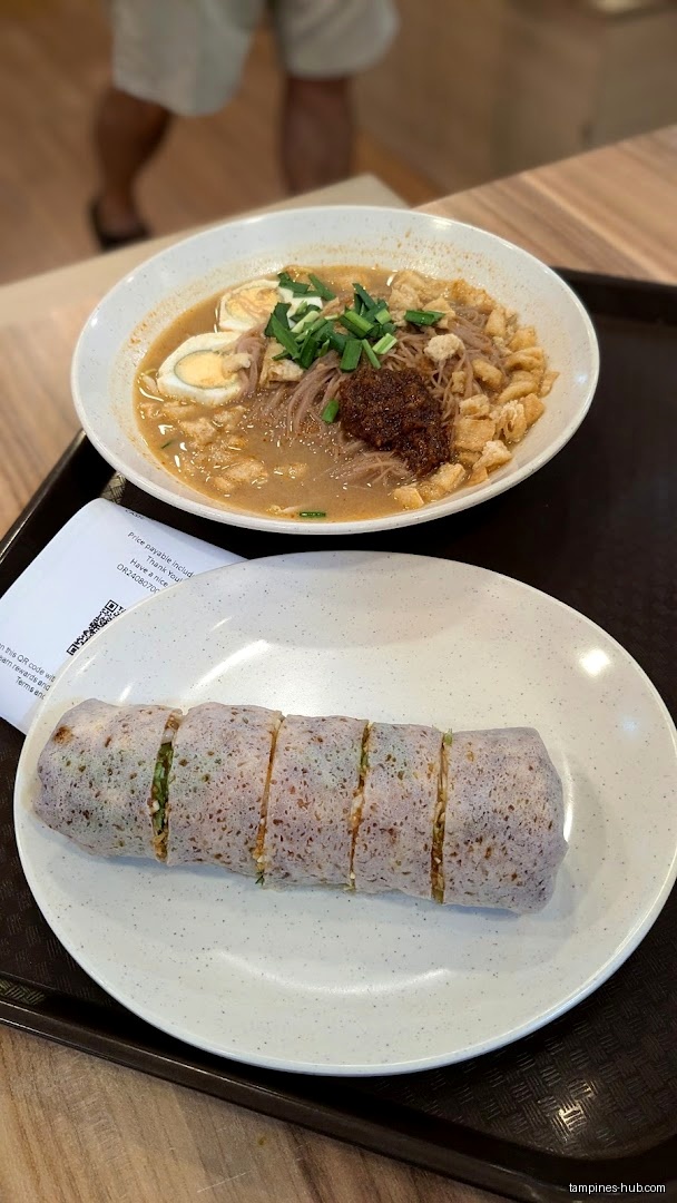 The image shows a bowl of noodles and a plate of popiah.