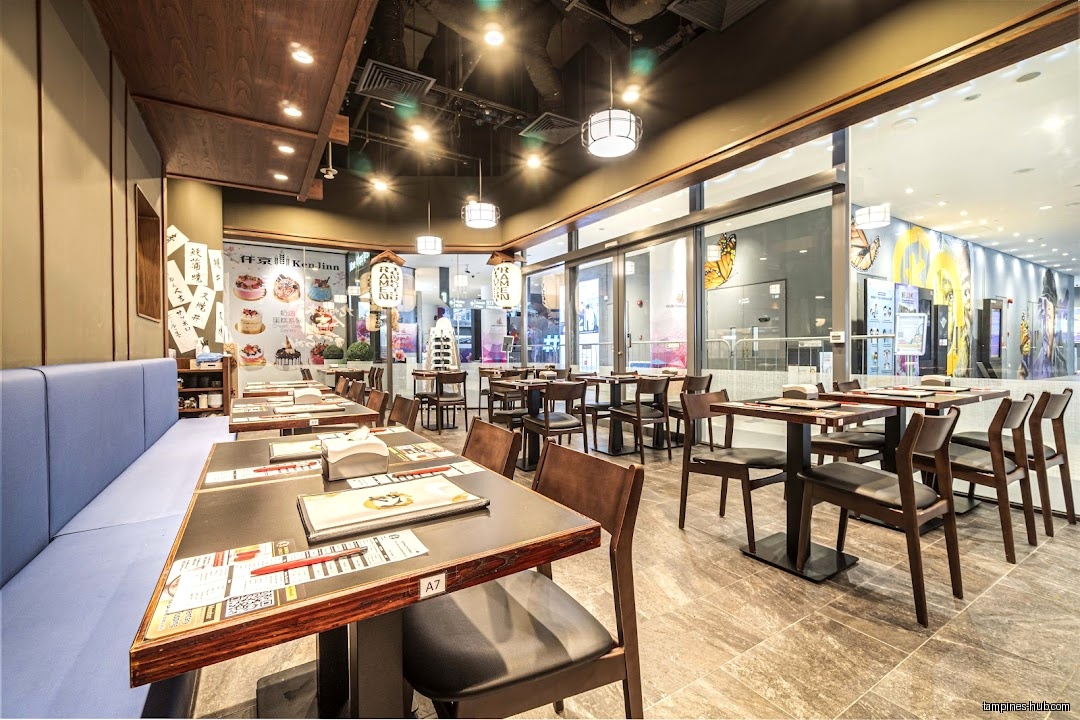 Interior view of Ramen Hitoyoshi restaurant with tables and chairs.