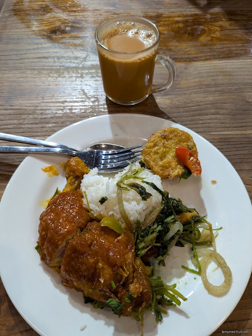 A plate of food with chicken, rice, vegetables, and a drink.