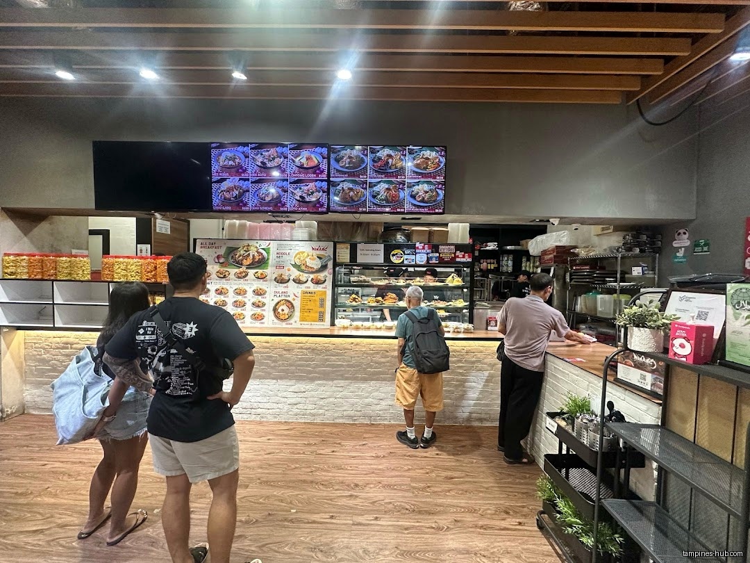 Customers are ordering food at Rumah Makan Minang restaurant counter.