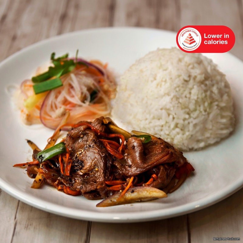 A plate of Thai food with rice, meat, and salad is shown.