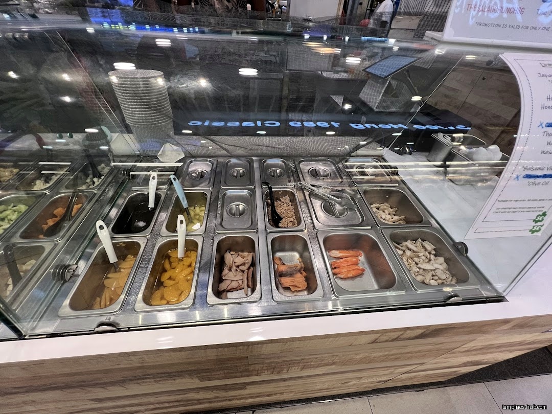 Salad Crunch's salad bar display with various toppings and dressings visible.